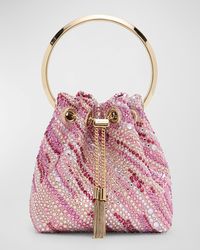 "Find JIMMY CHOO Embellished Bucket Bag on Editorialist. The Jimmy Choo \"Bon Bon\" bucket bag is crafted from embellished viscose and silk. The bag features a metal top handle, chain crossbody strap, and a chain drawstring closure. It can be worn as a top handle or crossbody bag. The bag measures approximately 5.9\"H x 5.5\"W x 3.7\"D and weighs 0.9 lbs. Made in Italy."