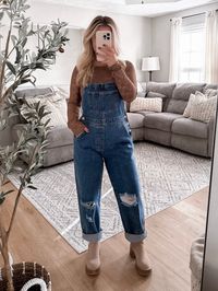 Model is 5'1", 34D, 6/28 and is wearing a size small. Item runs true to size with a relaxed denim fit. Our Macintosh Overalls features a medium wash true denim material with distressing in knees, adjustable straps, functional buttons on side of waistline, straight leg fit. Inseam approx. 28" (see last picture for 5' 8" model unrolled) More details: 43% cotton 29% viscose 28% polyester. hand wash or wash on cold and hang to dry.