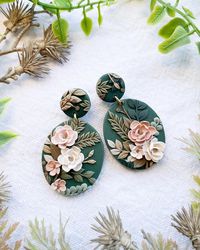 Upgrade your style with our handmade clay floral earrings! Made from high-quality polymer clay, these earrings feature a stunning black base with a beautiful pink floral design. Sensitive skin friendly gold plated brass. These earrings are perfect for anyone who loves bold statement accessories that also exudes elegance. Each pair of earrings is carefully crafted by hand, ensuring that you receive a unique and one-of-a-kind accessory. The lightweight material makes them comfortable to wear all d