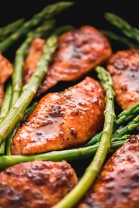 This sweet and savory Honey Garlic Chicken & Asparagus is all cooked in the same skillet and is ready to eat in less than 20 minutes! This is sure to be a family favorite for those busy school nights. #easydinner #chickendinner #chickenrecipes