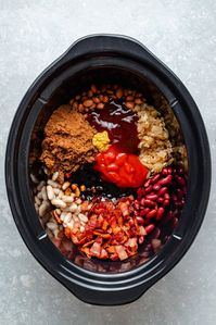 Delicious homemade slow cooker baked beans even better than the ones you grew up on! This easy baked beans recipe uses three types of canned beans, is perfectly sweet with a kick of heat if you'd like, and is easily made vegetarian. Add them to nachos or quesadillas, serve them as a dip and more!