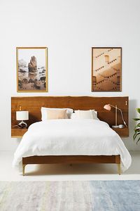 Showcasing the fluidity of live-edge oak, this modern bed fuses floating nightstands into its organic, brass-accented headboard for an *of the moment* three-in-one silhouette. For ordering assistance and more, please contact us. For aesthetic advice and tips to help decorate your space, enjoy our complimentary home styling services.