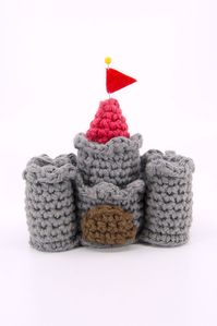 Learn how to crochet a castle or sandcastle with this crocheted castle pattern and video tutorial! This crochet pattern includes instructions on how to crochet your castle in different sizes and with a drawbridge that can actually be pulled up!

This crochet pattern even includes a full length video tutorial!