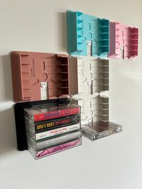 Modular cassette tape wall display. Holds 5 x audio cassettes using removable adhesive tabs. Will mount to most walk surface(including textured) without leaving marks. Available in a range of colours.