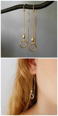 A pair of gold threader earrings with textured circles and beads