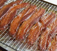 This Candied Bacon Recipe should be illegal. It IS that good! Glazed bacon that is sweet, salty, crispy and super addictive. This apple butter glazed bacon is perfect for any meal or occasion!