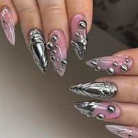 "Metallic Majesty" Press-On Nail Set by Jerry Nails 🌑🔗 Unleash your inner strength with the "Metallic Majesty" Press-On Nail Set, an embodiment of power and elegance. This collection marries the boldness of metal with the subtlety of art, perfect for anyone who loves to make a statement with their style.  Key Features & Highlights: 🔩 Sculpted Metallic Accents: Each nail features unique metallic sculptures that catch the light and eyes alike. These high-shine elements are designed to mimic the flow of molten metal, solidified into stunning patterns. 🌑 Polished Metal Finish: The nails boast a mirror-like metallic finish that provides a sleek and sophisticated look, reflecting your surroundings and enhancing the depth of the design. 🔗 Intricate Beadwork: Embellished with carefully placed