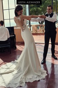 This gown is all about elegance. With a Sabrina neckline, this fit and flare wedding gown is sure to accentuate your figure. The illusion back is outlined by Venice lace that is also featured along the back hem. The gown is finished with chapel length train.