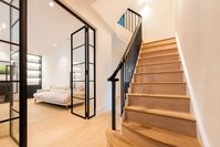 Entrace hallway in full house refurbishment. Polished banister with metail rails. Crittall doors.