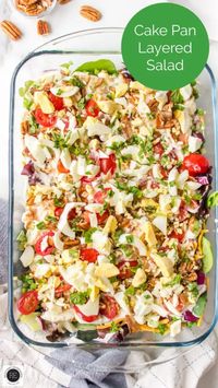 Cake Pan Layered Salad has layers of chopped lettuce, peas, onion, cauliflower, bacon, hard-cooked eggs--topped with a sweet summer dressing.