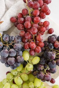 red grapes, green grapes, black grapes on a table