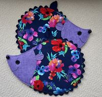 These cute little hedgehogs are made using floral print and lavender blender cotton fabrics. I appliqué the mouth, add buttons for the eyes and nose, navy Rick rack around the body and a loop for hanging. Insulated and cotton battings are used inside and also a layer of fusible fleece. All potholders are sold in pairs and are machine washable. Size 7 1/2 x 9 1/2 This pattern is available at Susiecshore.com