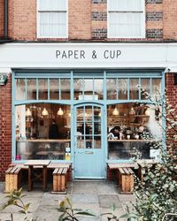 Cute brick exterior with pale turquoise door and windows