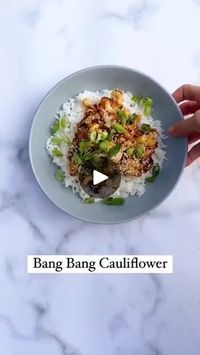 23K views · 45 reactions | Would you try bang bang cauliflower?! by vegandiaries

.
.
BANG BANG CAULIFLOWER
Serves 2
1 head of cauliflower
3 garlic cloves
1 long red chilli
1/4 cup raw cashews
1 tbsp maple syrup
2 tbsp soy sauce
2 tbsp water
2 tbsp rice wine vinegar

To serve:
Spring Onion
Sesame seeds
Cooked white rice

METHOD
1. Preheat oven to 200C, cut cauliflower into small bite-size florets, coat in oil, season with salt and pepper, place on a baking tray, cook in the oven for 18-20 mins until golden *tip use the whole cauliflower, place the leafy stems into the oven at the last 8 minutes.
2. Finely chop garlic, and fresh red chilli (de-seed to preference), Heat oil in a pan on a medium heat, sauté garlic and chilli for 2-3 minutes, add soy sauce, rice wine vinegar, maple syrup, wate