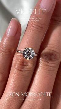 Michelle engagement ring has a solitaire design, 4 classic X claw prongs, a hidden halo and a 1.7mm gold band with accent stones, set with a center 7.5mm (1.5cte) OEC round moissanite gemstone.🌹  Zen Moissanite jewelry pieces are custom made, ethical and durable Diamond alternatives.✨