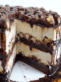 This dreamy Snickers Peanut Butter Brownie Ice Cream Cake is made with layers of fudgy brownie, no-churn peanut butter ice cream, chopped Snickers, chocolate and caramel sauce! #icecreamcake #homemadeicecream #nochurnicecream #snickers #browniecake #layercake #homemadeicecreamcake #peanutbuttercake