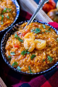 This hearty Puerto Rican stew filled with shrimp, rice, and peppers, is like a shrimp gumbo that is called Asopao de camarones. Perfect for rainy and cold days! #asopao #PuertoRicanstew #shrimpgumbo #riceandshrimp