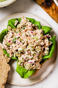 An overhead view of tuna salad on a bed of lettuce.