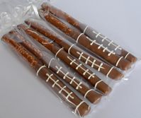 "These delicious Football themed pretzels are sure to be a hit! Dipped in Milk chocolate and embellished with white Chocolate. These beautifully detailed pretzels will definitely get some attention at your next team party, birthday or tailgate. This listing is for 12 Chocolate Covered Pretzel Rods. I wrap 2 Rods per bag. So you will receive 6 bags with 2 pretzels in each bag. Please just let me know if you need them individually wrapped. These are a fun and unique way to add a personal touch to