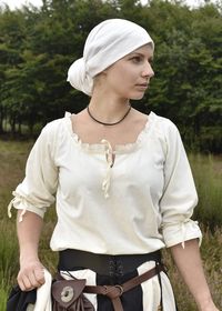 This versatile blouse has a small ruffle at the neckline. The split neck is closed at the front with a ribbon tie. The sleeves are 3/4 length and gathered with a tie. Small slits on the side seams allow for better freedom of movement. The blouse is made from light cotton fabric and is very comfortable in fit. Historically, blouses should be assigned to the Renaissance rather than the Middle Ages. However, when combined with a skirt and a bodice or a corset belt, they make for a beautiful medieva