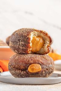 Pumpkin Cream Filled Donuts are soft, moist and fried to a golden perfection. They are stuffed with a smooth, creamy pumpkin filling and rolled in cinnamon sugar for a sweet finish! #sugarhero #filleddonuts #pumpkindonuts #homemadedonutrecipe #pumpkindonutrecipe #breakfast #fall #doughnuts