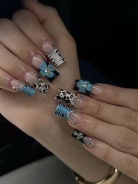 Cheetah print blue nails with a cross nail and 3d flower