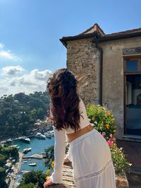 Ocean views from Portofino italy in an all white outfit. White top and white skirt