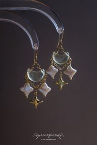 ---- Welcome to CiaoQiao Shop ----- Illuminate your style with the ethereal beauty of our "Enchanted Celestial Charm Earrings." Carefully crafted to capture the whimsical allure of a starry night, these earrings feature genuine baroque pearls fashioned into delicate stars, each one unique in its luster and form. Dangling gracefully from a chain of gold, they accompany a golden crescent moon, creating a celestial dance of elegance and charm. The stars and moon are suspended from a fine gold-tone