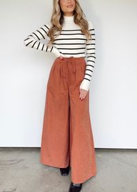 Sophisticated yet comfortable, the Sierra Sunset Pants make a perfect outfit for any occasion. Featuring adjustable drawstrings, pocket details, and a chic pleated design, these pants provide an elevated, statement look with a pop of color. With their high-waisted fit, soft fabric, and stylish wide-leg design, you can easily go from the office to dinner or drinks in style. 92% Polyester 8% Nylon Hand wash cold.