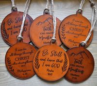 "Our CR Maxson Christian Ornaments are laser engraved with encouraging Bible Verses. These are a lovely and unique handmade ornament and will make a wonderful addition to your home decor as they are sweet reminders of God's Truth. Pick your favorite Bible Verse and hand stained finish from the drop down menu . Which one is your favorite? While our leather ornaments make excellent Christmas ornaments, they can also be given as inspirational gifts for friends and family all year long! Our Leather