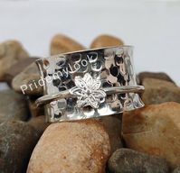 Check out this item in my Etsy shop https://www.etsy.com/in-en/listing/811191516/stylish-flower-spinner-band-rings