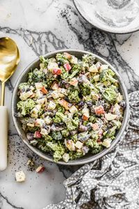 Creamy, crunchy Broccoli Apple Salad with dried cranberries, almonds, sunflower seeds and onion tossed in a creamy poppyseed dressing.