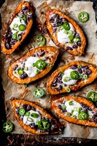 Delicious chili stuffed sweet potato skins that make the perfect game day appetizer or easy vegetarian lunch! Topped with melted cheese and a scoop of honey-lime chipotle yogurt sauce. This recipe is sponsored by BUSH’S® Beans.