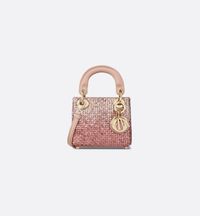 The Lady Dior micro bag embodies the House's vision of elegance and beauty. Crafted in pink satin, the exceptional style is entirely embroidered with tonal sequins enhanced by a gradient effect and further embellished with a D.I.O.R. charm. Featuring top handles and an adjustable and removable shoulder strap, the Lady Dior bag will accommodate any small essentials and can be carried by hand, worn over the shoulder or crossbody..