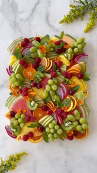 30min · 8 servings     Here’s what I used:  • cantaloupe   • honeydew   • pineapple  • green grapes  • kiwis  • cara cara oranges   • tangerines   • raspberries  • cherries  • dragon fruit   • mint   • edible flowers   Before building your board, slice and prepare your fruit for easy assembly!