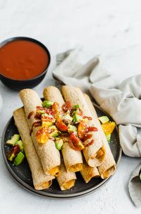 Slow cooker chicken and cheese taquitos is a delicious meal that the whole family will love! Be sure to make a double batch for the freezer. Then, you can pull out however many you want and throw them directly in the oven for a quick weeknight dinner.#easydinner #weeknightmeal #chickenrecipe #slowcooker #slowcookerrecipes #freezermeal #freezerfriendly #kidfriendly #freezercooking #freezermeals #slowcookermeal #slowcookerrecipe #crockpot #crockpotrecipe #crockpotchicken