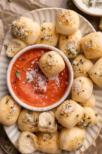 Make these cheesy parmesan bread bites in under one hour with simple pizza dough, parmesan cheese, fresh herbs, and garlic butter! A delicious and easy snack, appetizer or side dish. | Cambrea Bakes