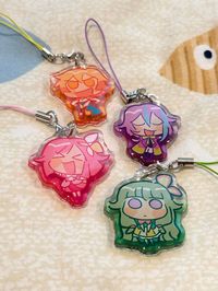 my clown children 1.5" double-sided acrylic charms with a transparent gradient, and are epoxied on both sides for a smooth/rounded finish! each keychain comes with a matching colored charm strap!