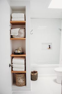 Bathroom open shelving and baskets. Neutral bathroom design ideas. Elongated subway tile. Terrazzo flooring. #bathroomdesign