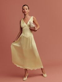 How classic. Shop the Stasia Silk Dress from Reformation, a sleeveless midi dress with a V-neckline, drop waist, and lace detailing.