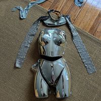 Futuristic, Metallic, Armor-Like Costume, Possibly Intended For A Performance, A Cosplay Event, Or A Themed Fashion Statement. The Reflective, Chrome-Like Material Gives It A Sci-Fi Or Robotic Vibe, Reminiscent Of A High-Tech Or Cyborg Character. It Is Highly Stylized And Likely Designed For Aesthetic Appeal Rather Than Functional Protection, Often Seen In Avant-Garde Fashion, Music Performances, Or Futuristic Themed Parties. The Intricate Metallic Details And Sleek Design Evoke A Futuristic Or