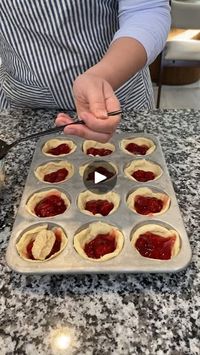 Easy Cherry Pastry Hack! | Easy Cherry Pastry Hack! | By Hanna and Zechariah | Pan of Pillsbury croissant
rolls. Crescent rolls. Just take em out peel em apart your dough here and you're
going to kind of just spread it out like this. Let's make it
into a little circle and you're just going to put that into
your muffin tin and spread up the sides. Super easy. Just
kind of connecting those corners. Get more of a circular
piece there and then just pinch it in along the sides. And you will need two packs of
two rolls of the crescent dough to fill a whole muffin tin
there we go we're all filled next we're coming in with a jar
of cherry pie filling oh yeah I get a little doll up in there
my issue is I always overfill I forget they gotta leave room to
rise so let's get a little bit of that out so