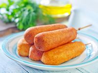 Pronto pups are similar to corn dogs but their batter contains less (if any) cornmeal than flour. They are hot dogs on a stick that are coated in a batter and deep fried.