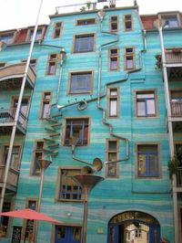 when it rains, the drain and gutter system attached to the building act as giant musical instruments.