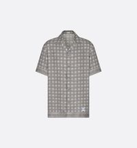 The short-sleeved shirt is defined by its graphic aesthetic showcasing the House's iconic allover Cannage motif. Made in gray silk twill, it is adorned with a contrasting Dior Charm woven tag on the front. Comfortable and easy to wear, the shirt will pair with the matching Bermuda shorts to complete the look.. 37