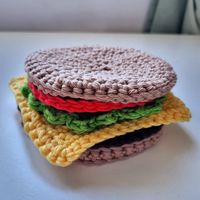 Do you love a good burger? Why not make your own cheeseburger coasters with this easy beginner friendly Crochet Pattern! This pattern is suitable for Crochet beginners and anyone learning to read a pattern for the first time. In this set of coasters pattern you will receive instructions on how to make a burger bun, burger patty, cheese, lettuce and tomato so you can put together your favourite burger ingredients and form your own signature set of coasters! All you need to make these coasters is: