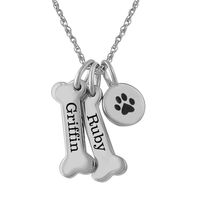 This adorable pendant features a paw charm and dog bones that can be personalized by engraving a special sentiment.