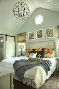 Swell Forever founder home featured in simply buckhead magazine. Remodeled 1940s cottage. Bari J floral prints. Lulie Wallace Anthropologie shams. Forever Blanket throw by Swell Forever in navy. Master bedroom style. Simple barn door ideas. Octagon window accent. www.swellforever.com