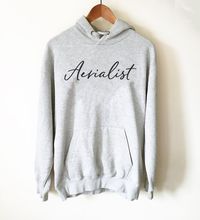 This Aerialist hoodie is so awesome! It's the perfect gift idea for anyone who loves aerial dance, hoop or yoga. What an awesome outfit for circus rehearsals and training! Both male and female dancers can wear this unisex sweatshirt. If you're struggling to know what to get the aerialist in your life, discover more gifts at Stag and Peach Co!  #clothing #hoodie #aerial #aerialistyoga #circus #gifts #dancer #dance #dancelife