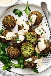 This easy falafel recipe creates crispy yet soft balls packed with chickpeas and plenty of fresh herbs and spices. They’re naturally vegan and vegetarian, and a staple in Middle Eastern cuisine. They can be added to wraps, pitas, shawarmas, salads, and so much more. Bonus - I’ll share how to make fried falafel and baked falafel for you to choose from!